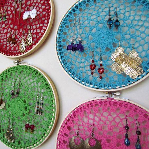 4 different colored dreamcatchers used as earring holders hanging on wall