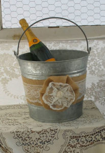 antique old pail with burlap and lace wrap holding champagne