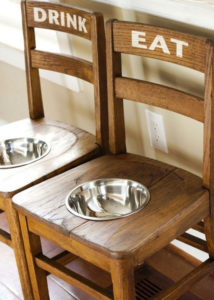 two chairs made into dog bowls with labels on back of chair