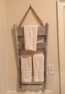 diy towel rack hanging on back of door made from back of old chair