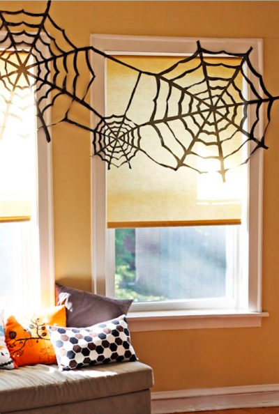 black paper cobwebs taped up in windowsill