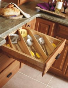 open kitchen drawer with organized utensils at a slant
