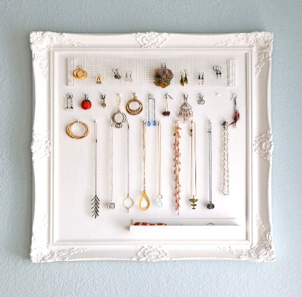painted picture frame holding hanging jewelry