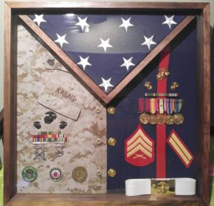 framed flag and military uniforms