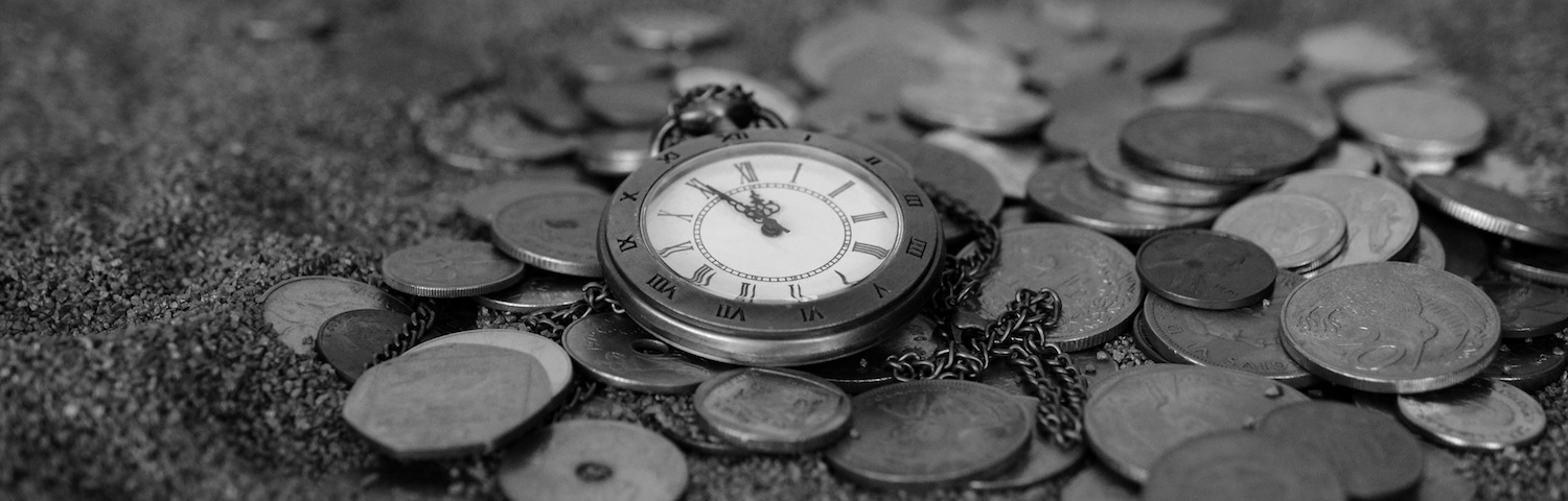 grayscale bed of coins with a open-face pocketwatch