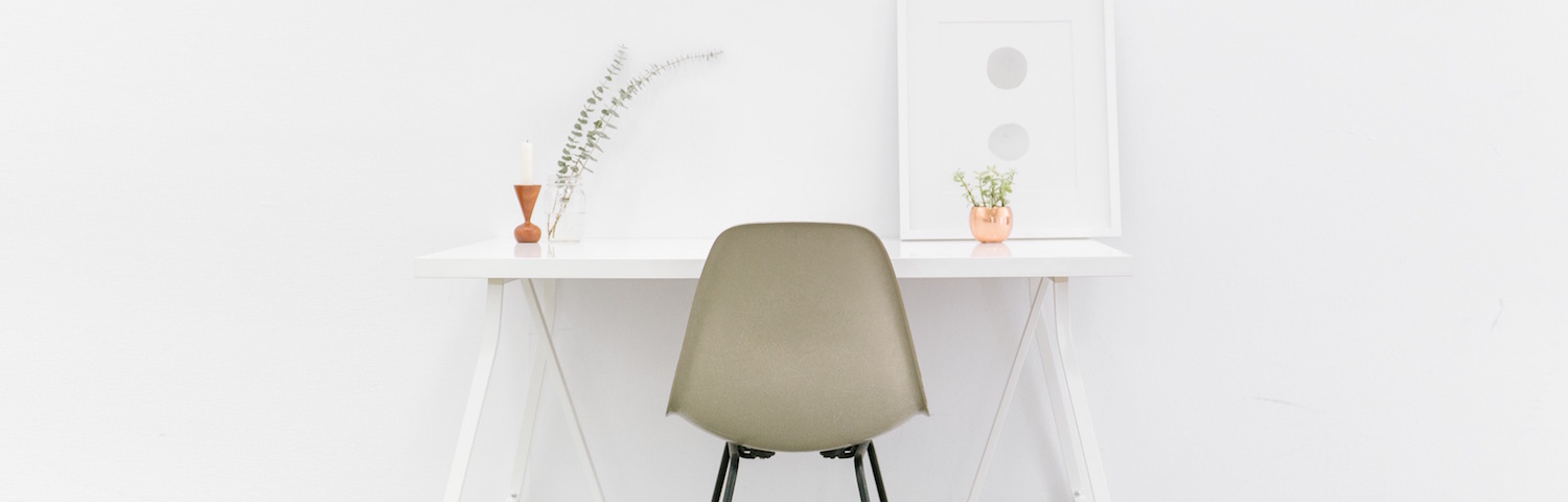 minimalist desk white wall with tan chair