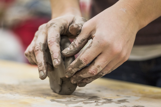 close-up of hands in molding clay