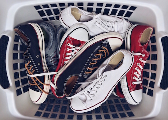 laundry basket full of multi-colored converse shoes