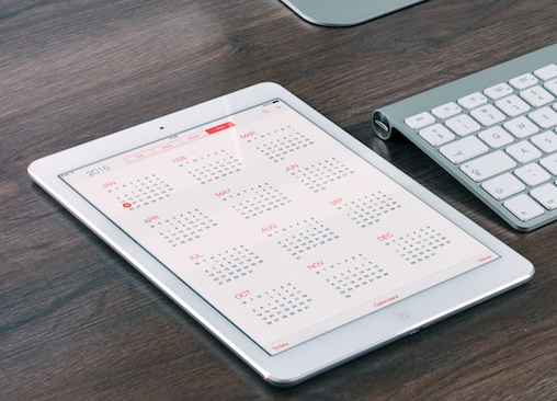 ipad on desk displaying calendar