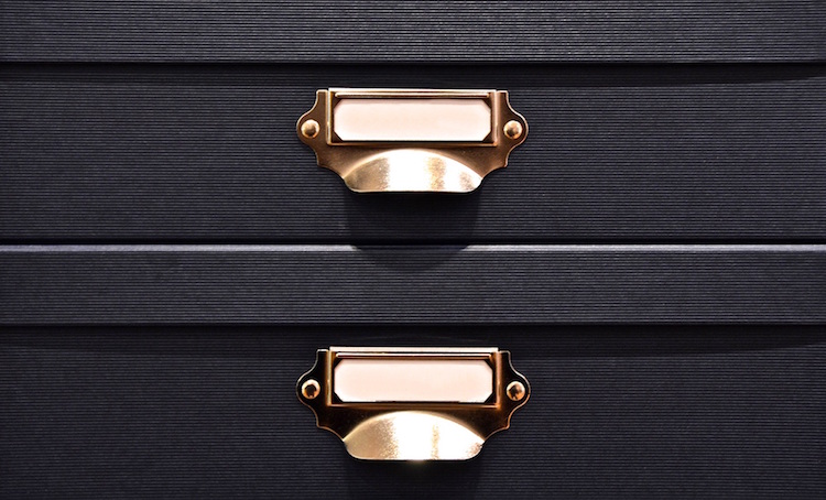 close-up of black box filers with handles
