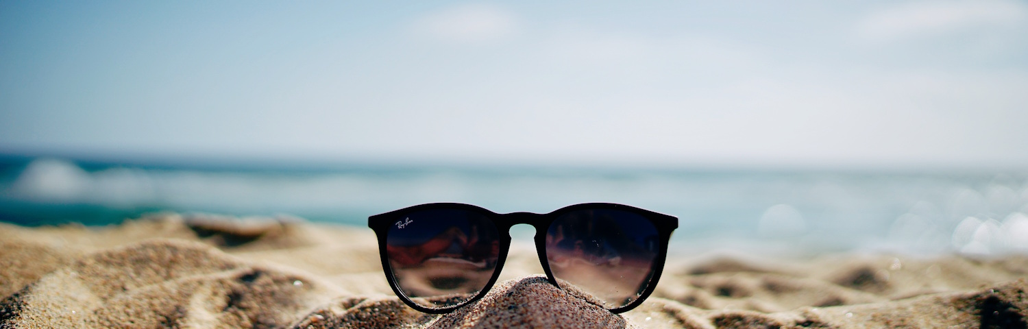 pair of sunglasses on the beach