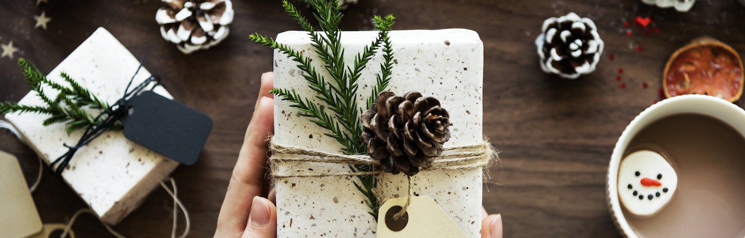 Urban Christmas present wrapping setting with pine cones and pine branches and labels