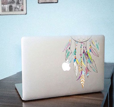 laptop on tabletop with dreamcatcher decal on top