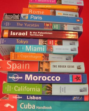 high stack of old guide books to european countries