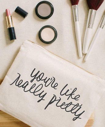 modern photo of make up surrounding makeup bag with cute saying on it