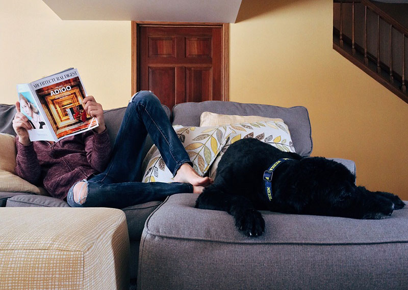 man reading magazine in living room