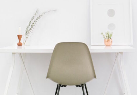 minimalist desk white wall with tan chair