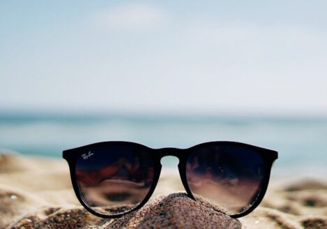 pair of sunglasses on the beach