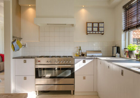 wide kitchen with big stove oven and white walls