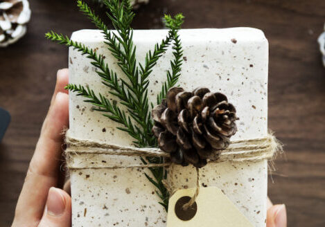 Urban Christmas present wrapping setting with pine cones and pine branches and labels